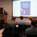 Dr. Taylor speaking at the podium during 20th Annual Research Symposium