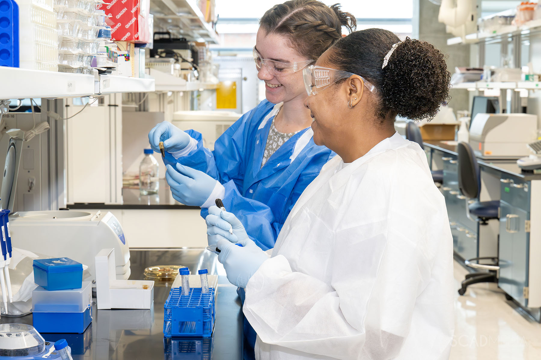 A student and faculty work in a chemical engineering lab.